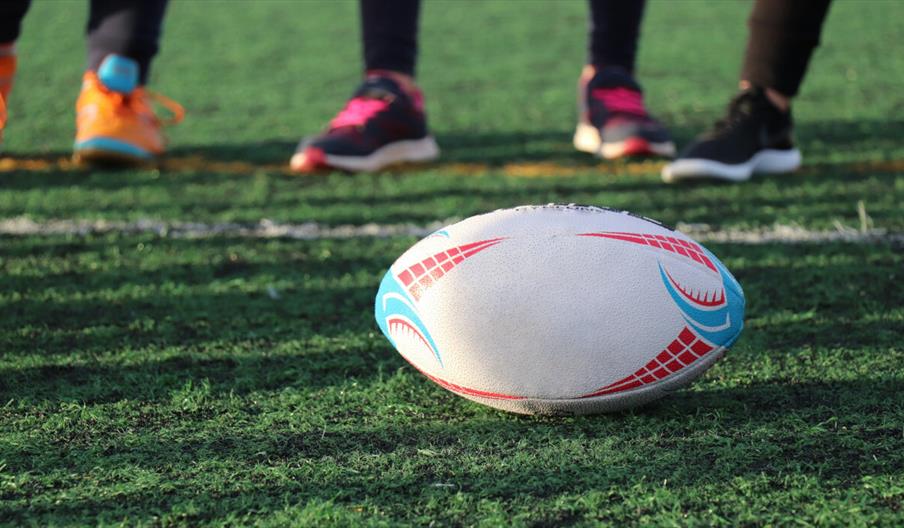White rugby ball on green grass