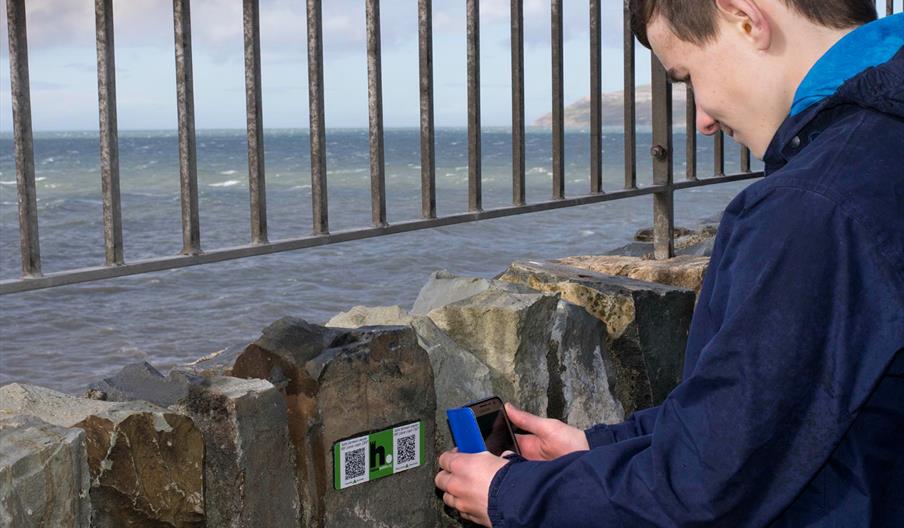 Person scanning QR code on a phone