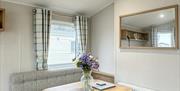 Chair and table with vade of flowers in wheelchair accessible caravan Abergele